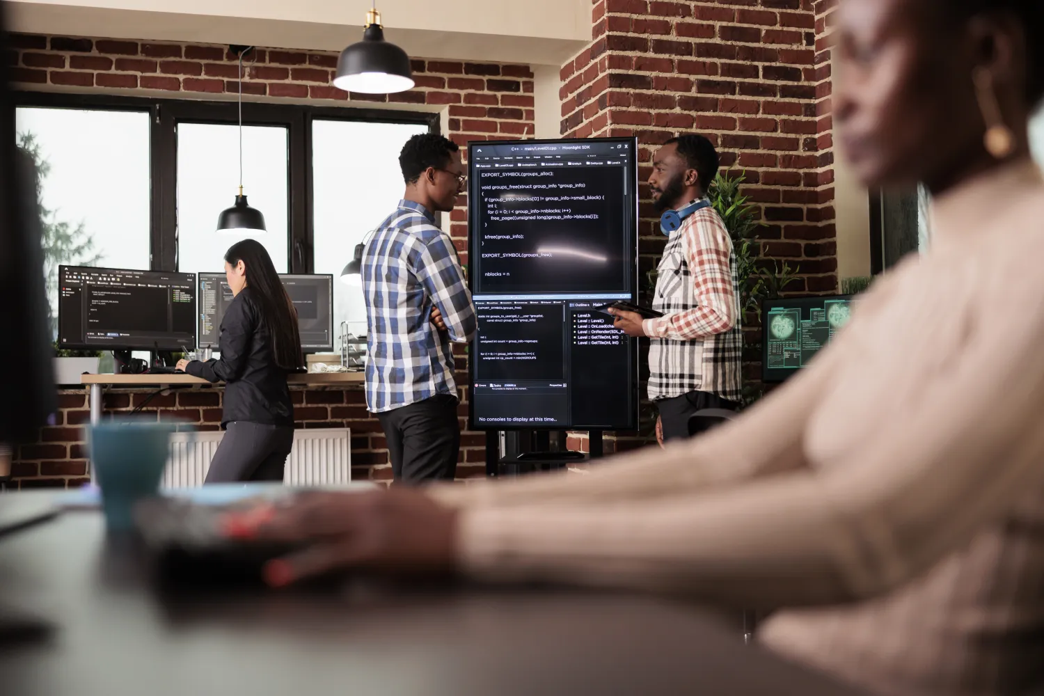 Specialists reviewing an AI project on screen