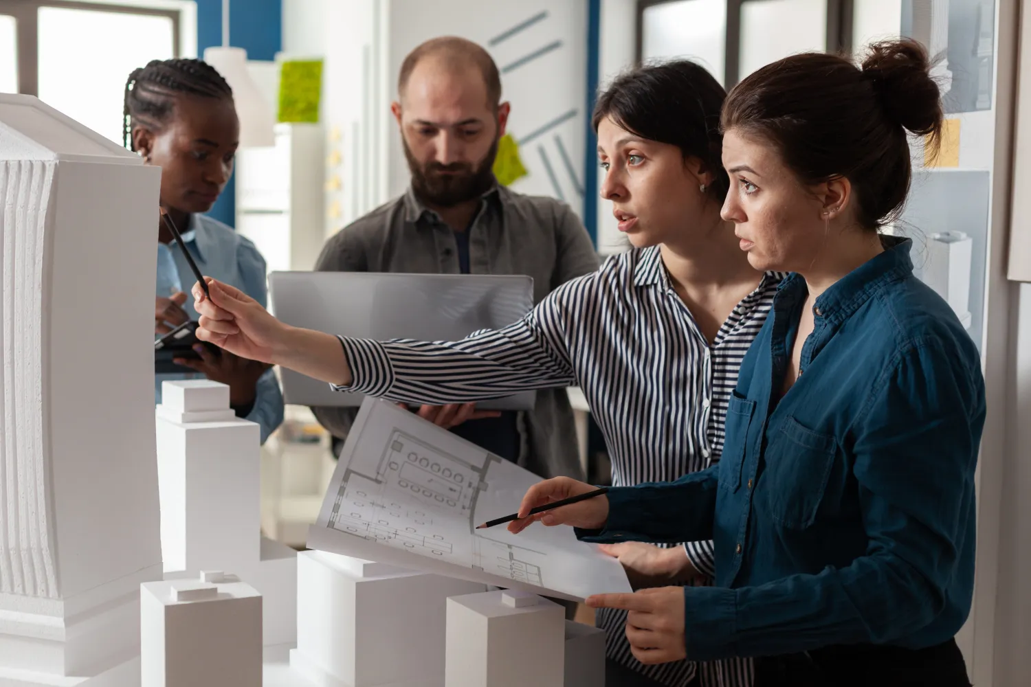 Architects reviewing blueprints together
