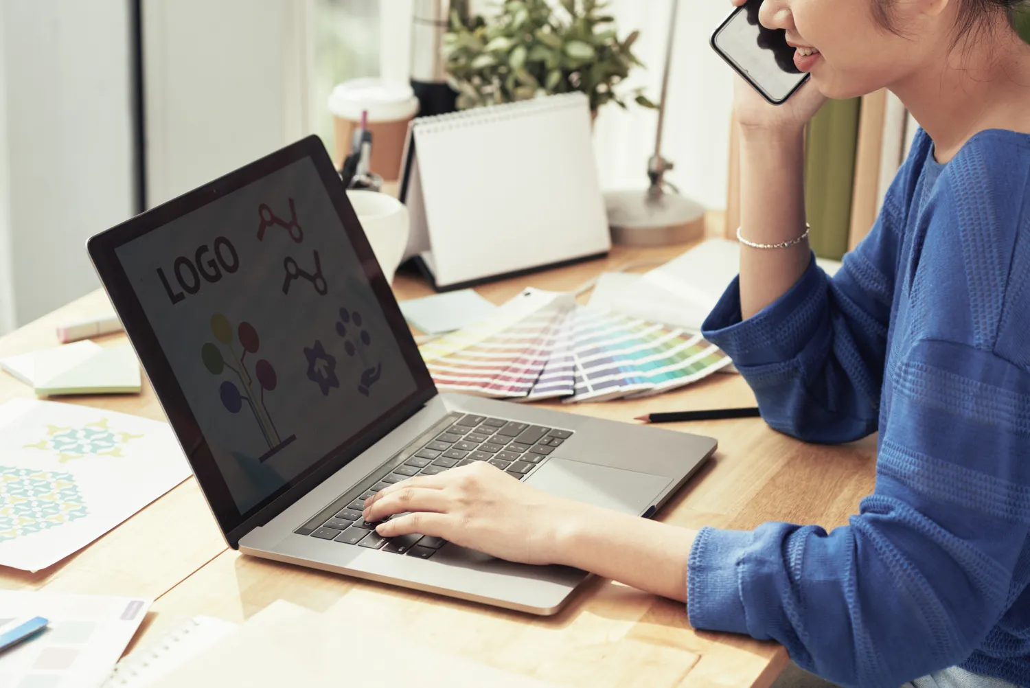 Designer choosing brand colours beside a laptop