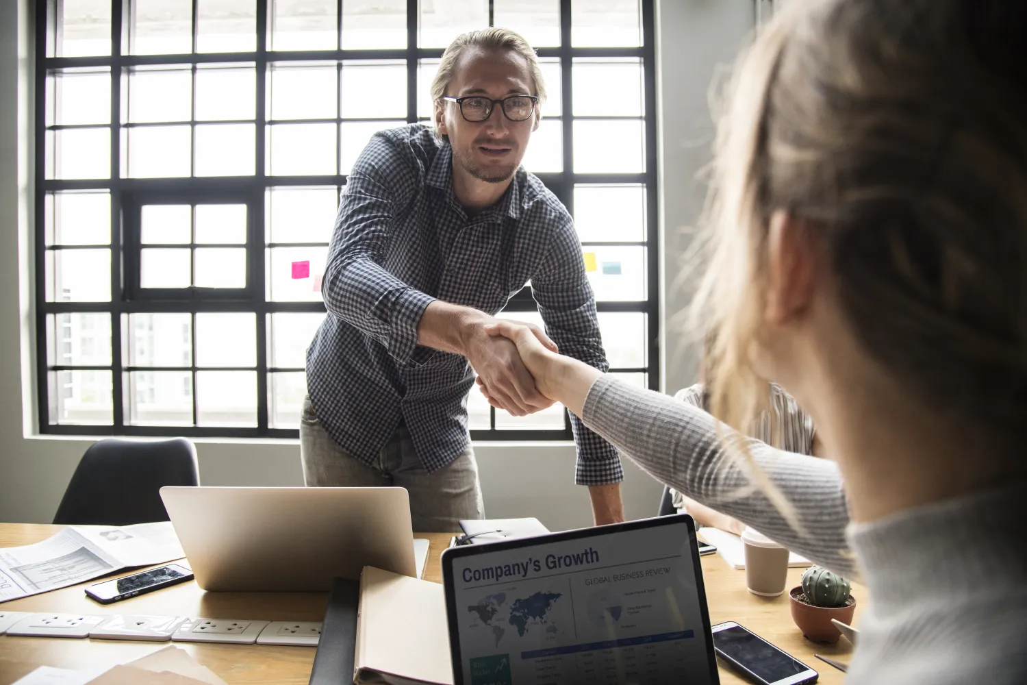 Business owner shaking hands with an SEO agency after agreeing to work together