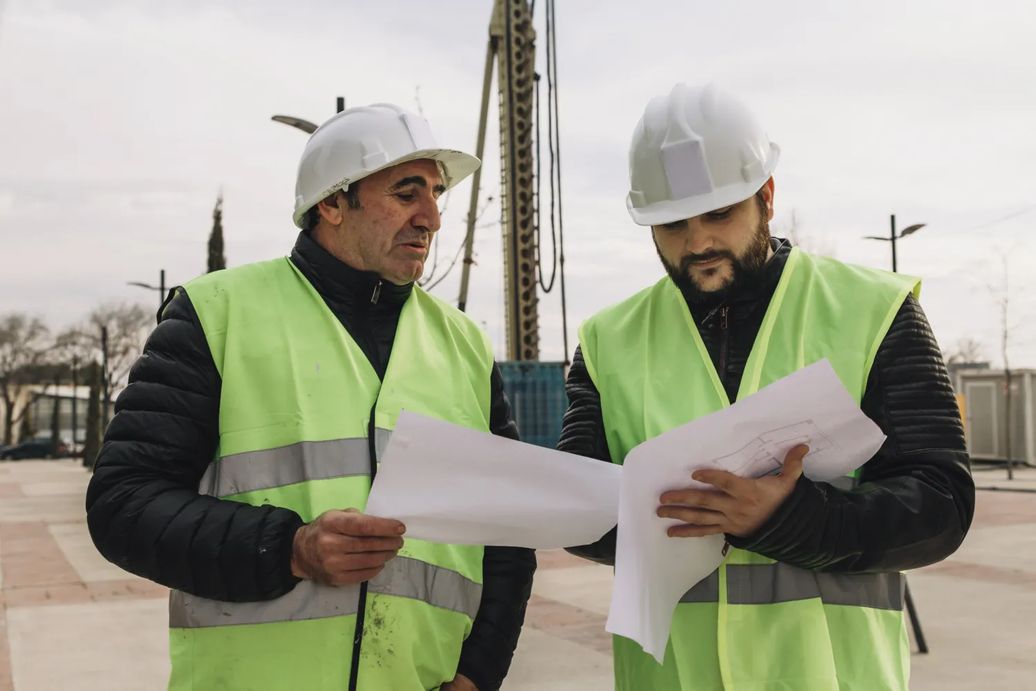 Construction workers reviewing plans on site