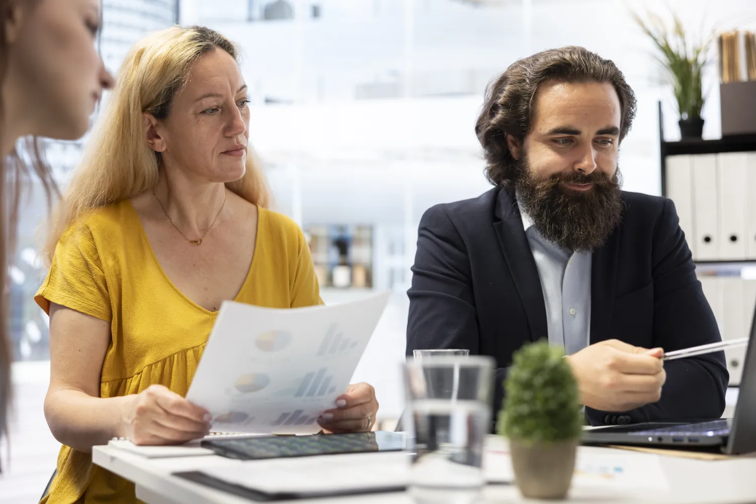 Adviser reviewing plans with a couple