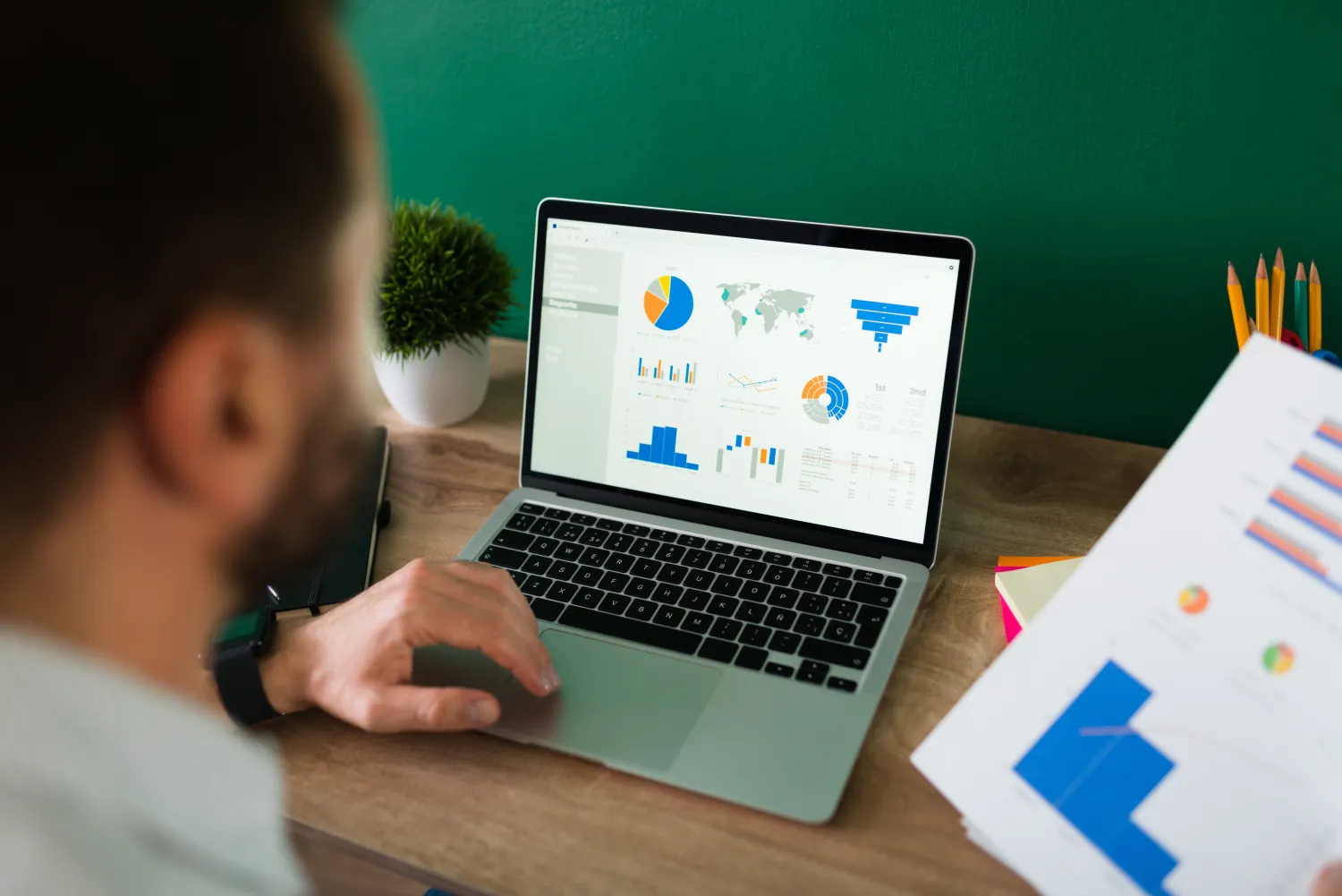 Marketer reviewing Google Ads performance and cost reports on a laptop