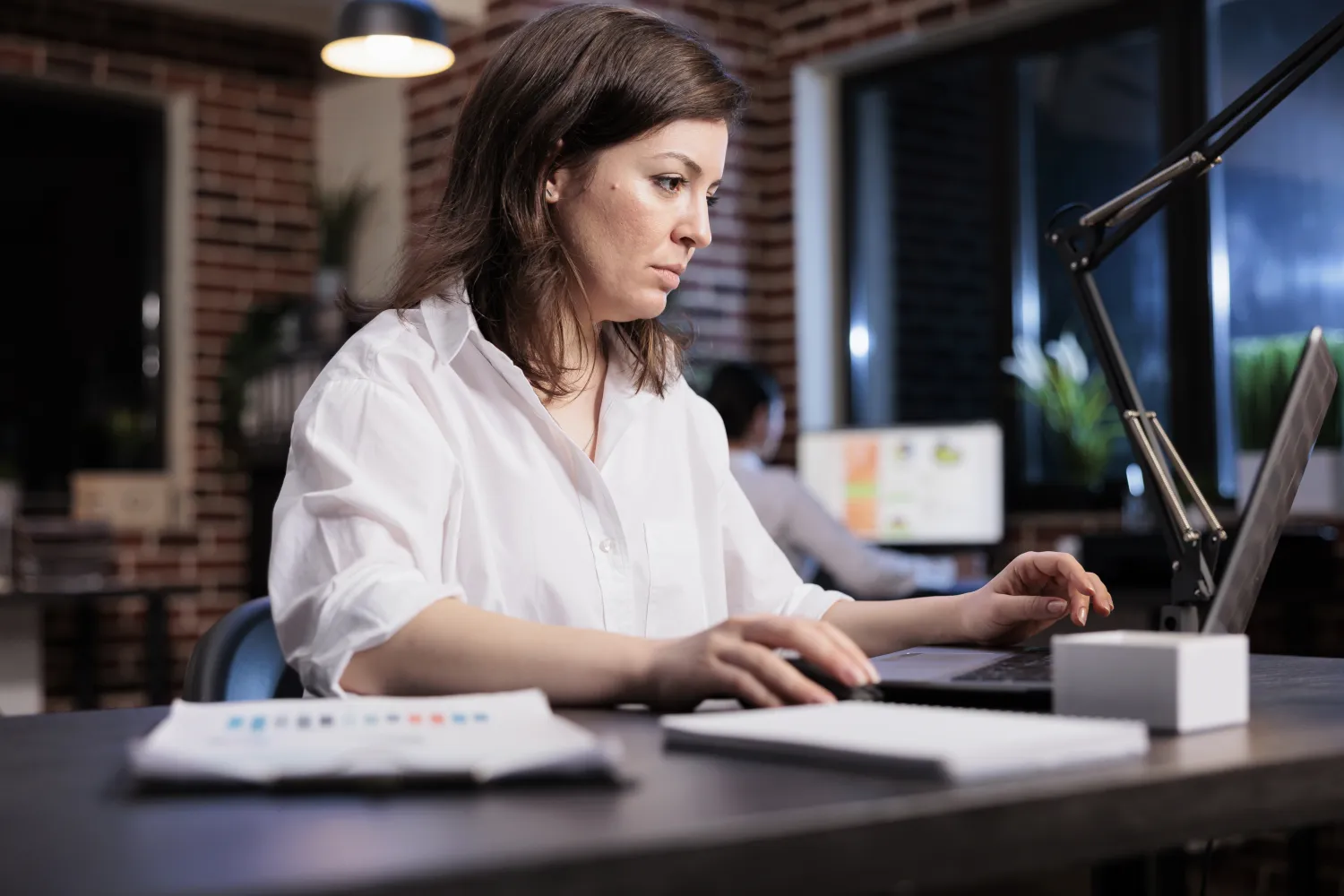 Marketer reviewing campaign data on a laptop