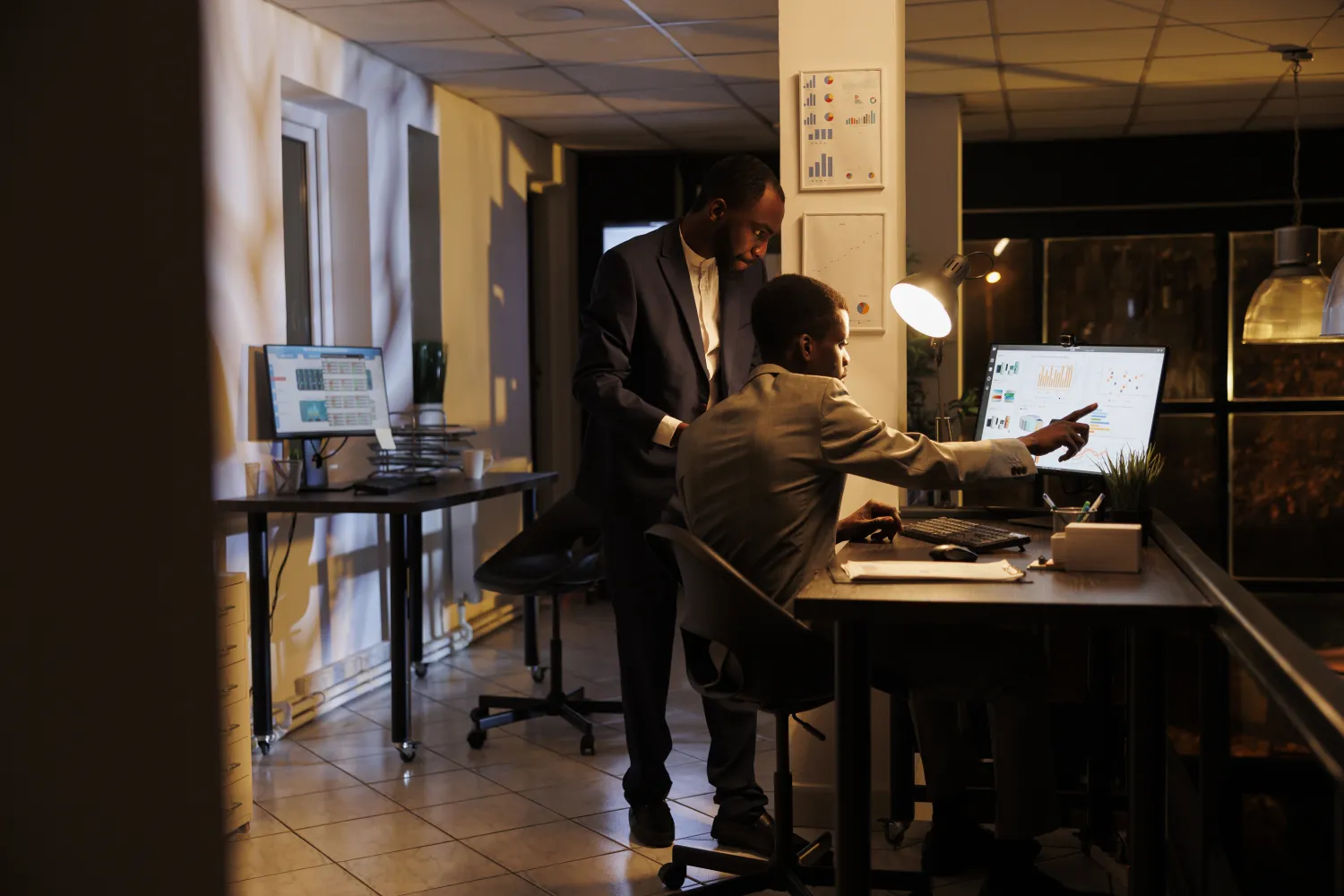 Managers reviewing marketing statistics on screen