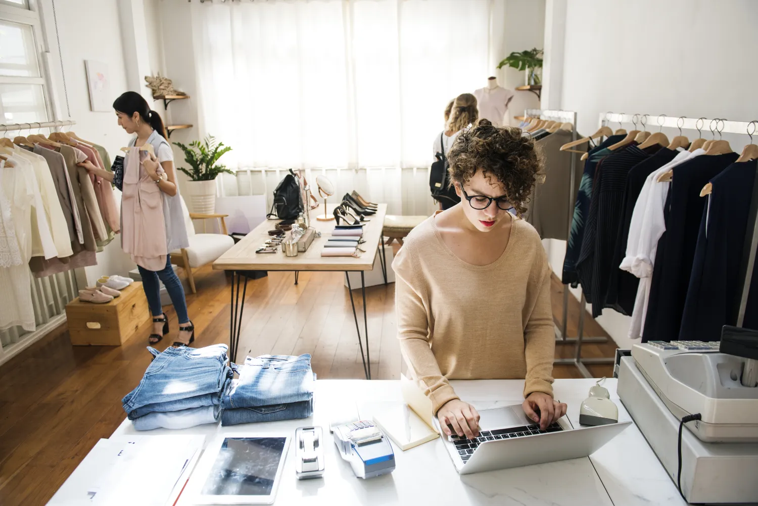 Small business owner managing their shop on a laptop