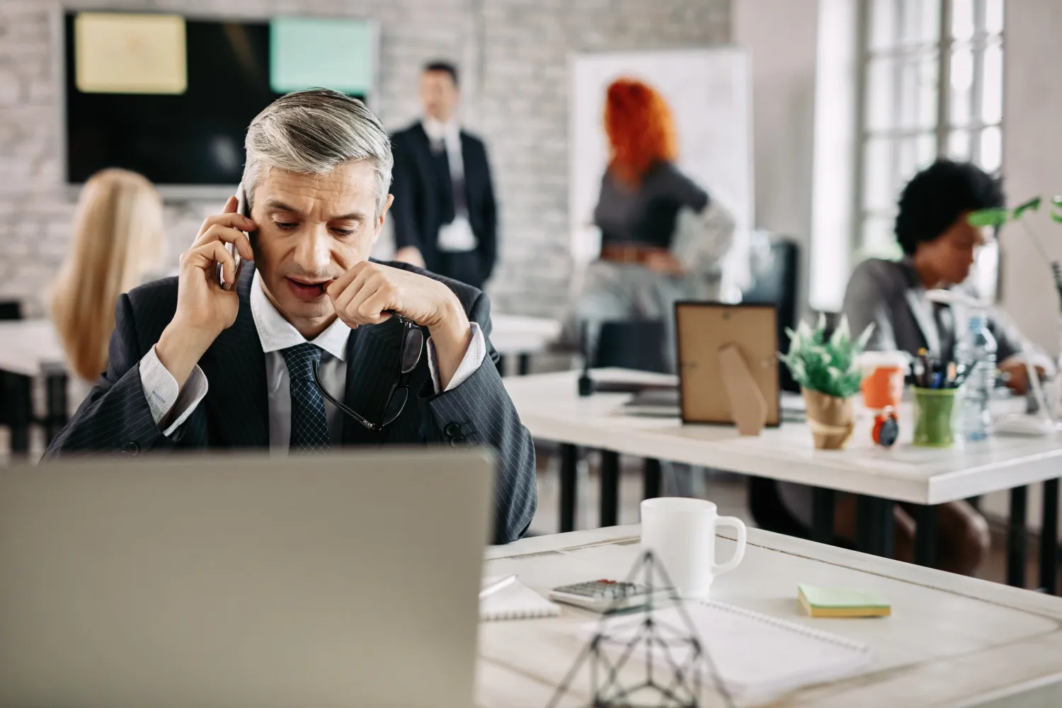 Salesperson following up with a new lead by phone in an office