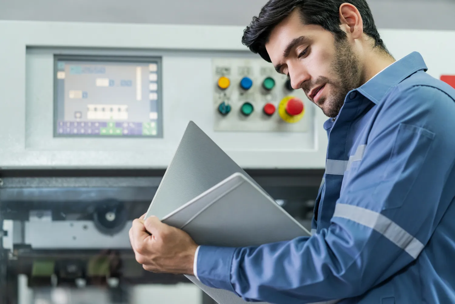 Engineer inspecting machinery in a factory