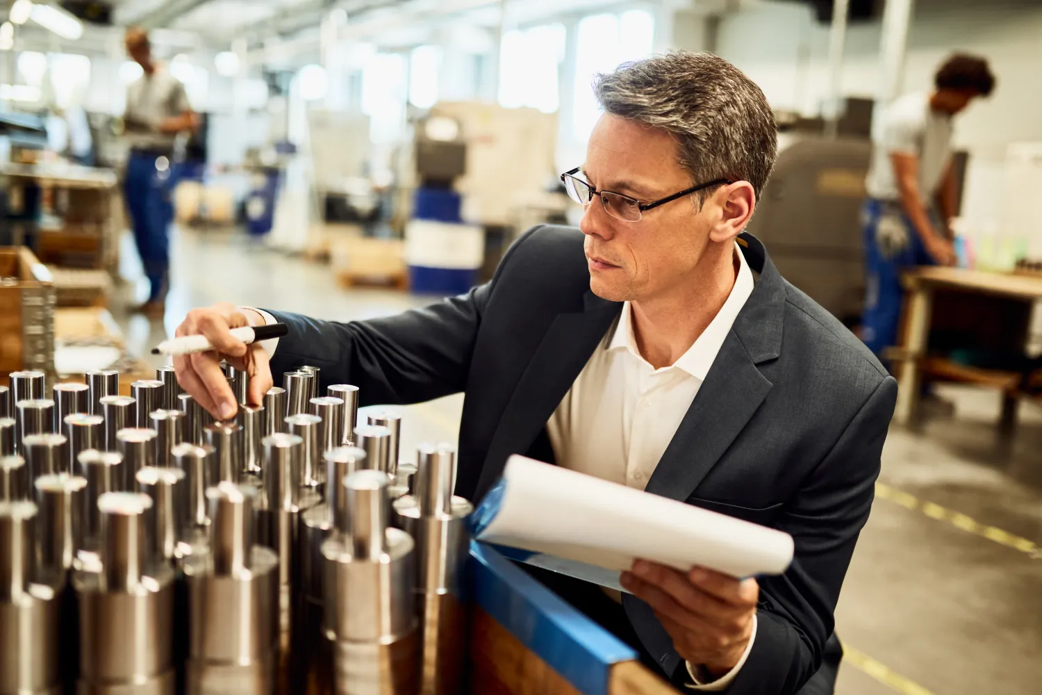 Quality inspector examining machined components