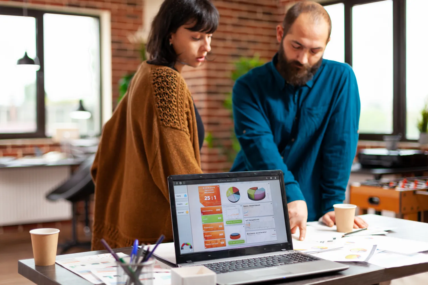 Team reviewing marketing data on a laptop