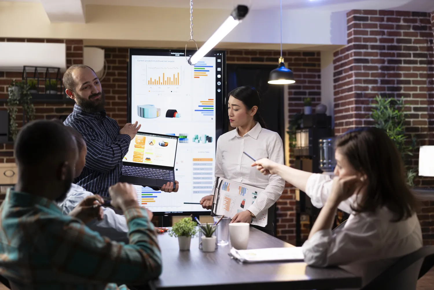 Professionals presenting performance charts