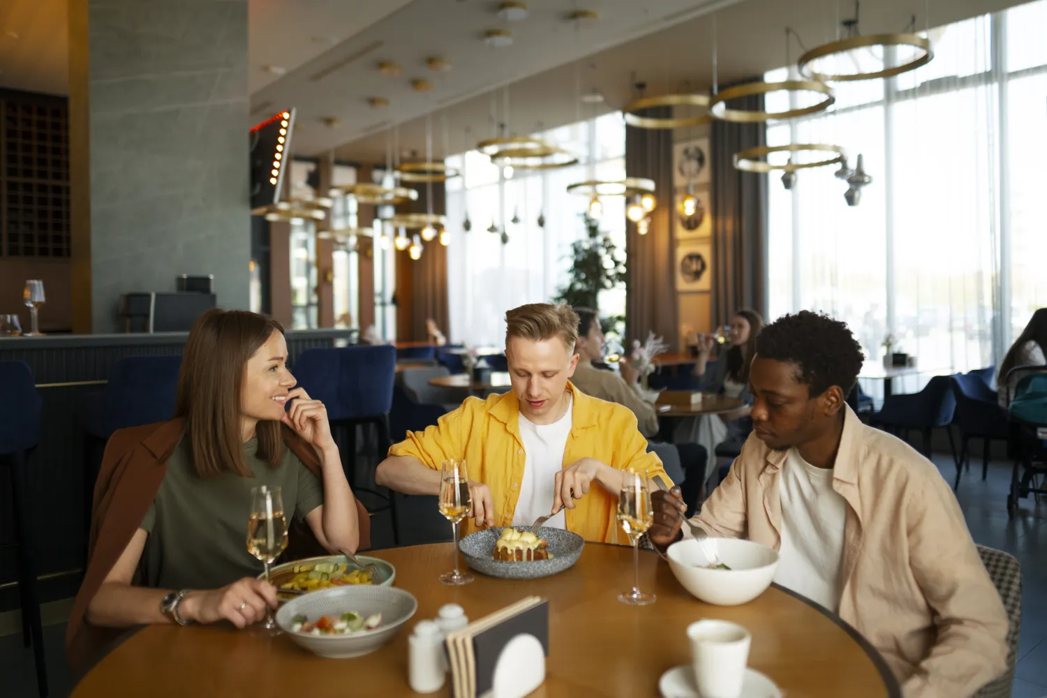 Diners enjoying a meal together in a busy restaurant
