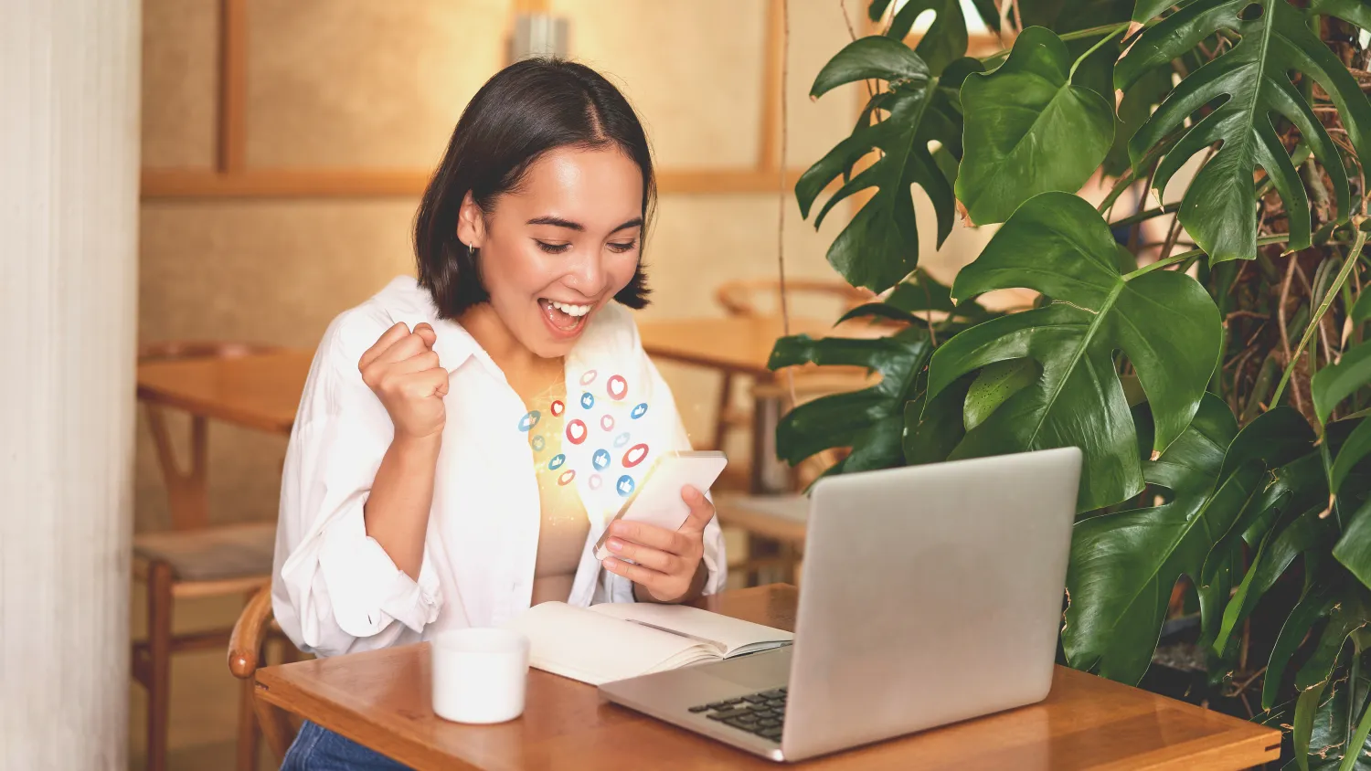Person engaging with content on a phone and laptop