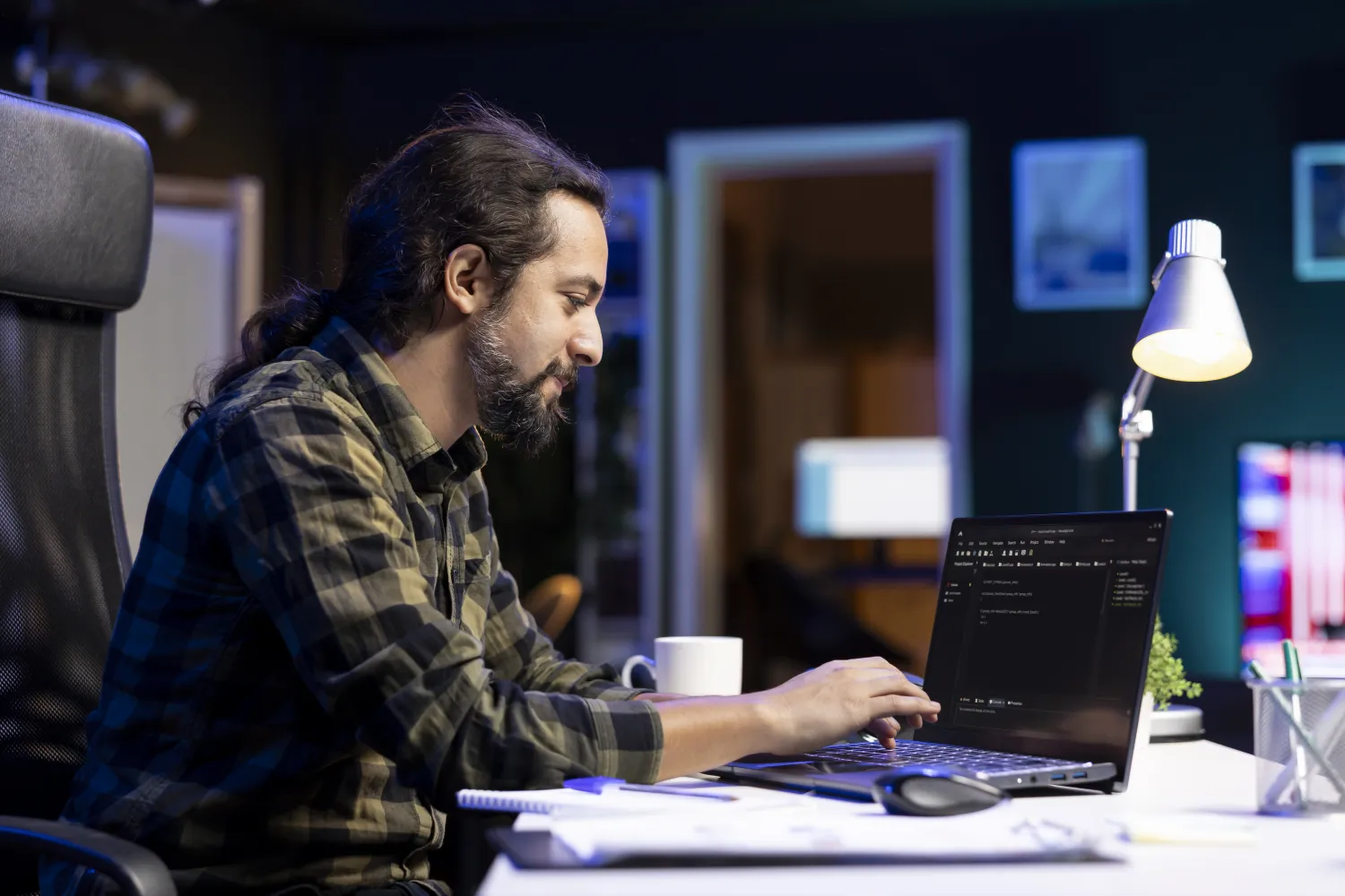 Developer optimising code at a laptop