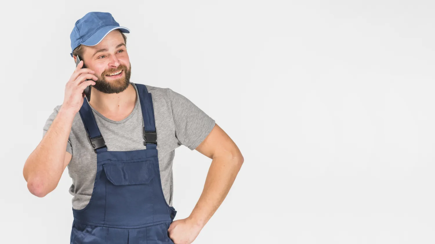 Tradesperson in workwear taking a job enquiry call on his phone