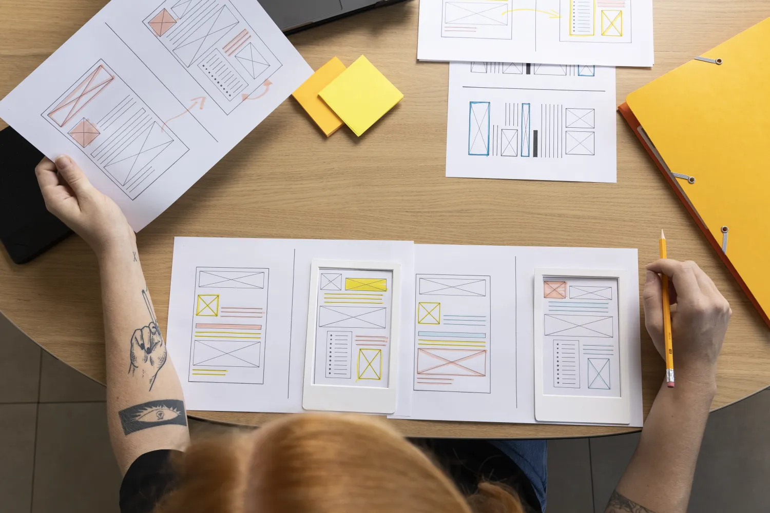 Web designer planning a website layout with wireframes