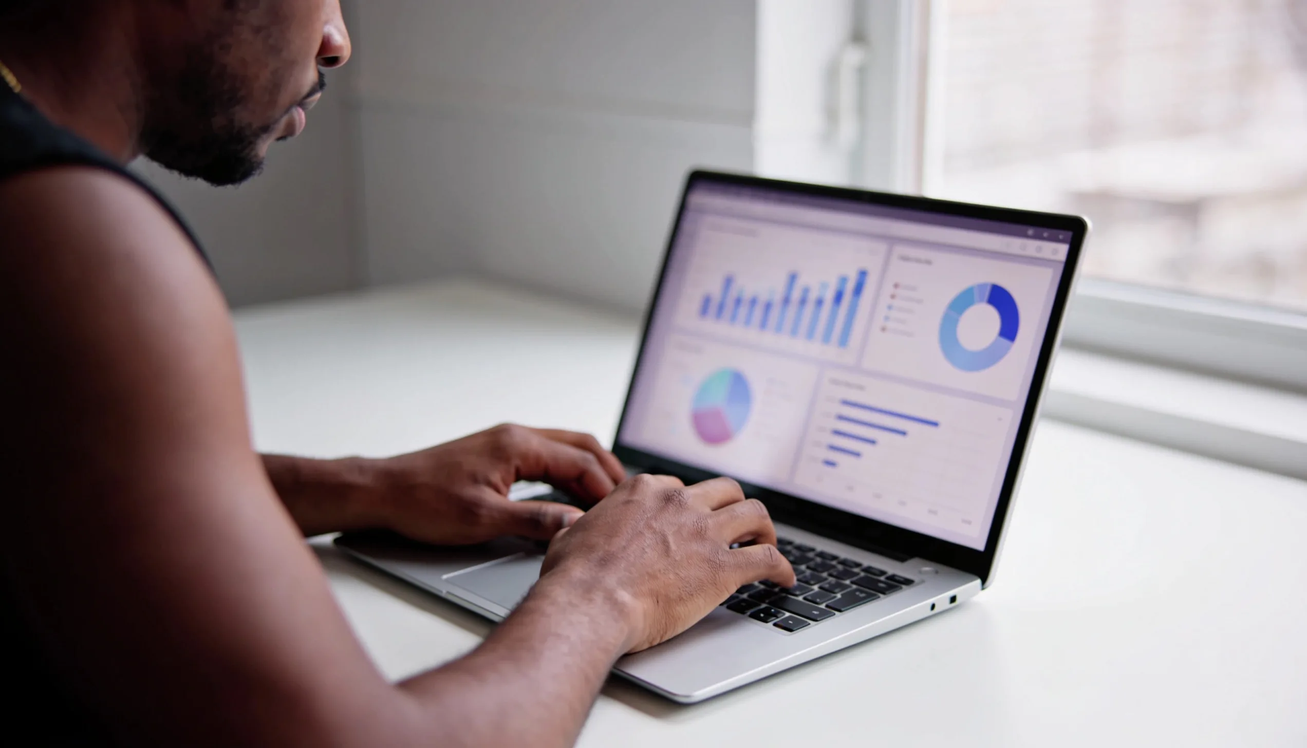 SEO analytics dashboard on a laptop showing website traffic, keyword rankings and performance graphs